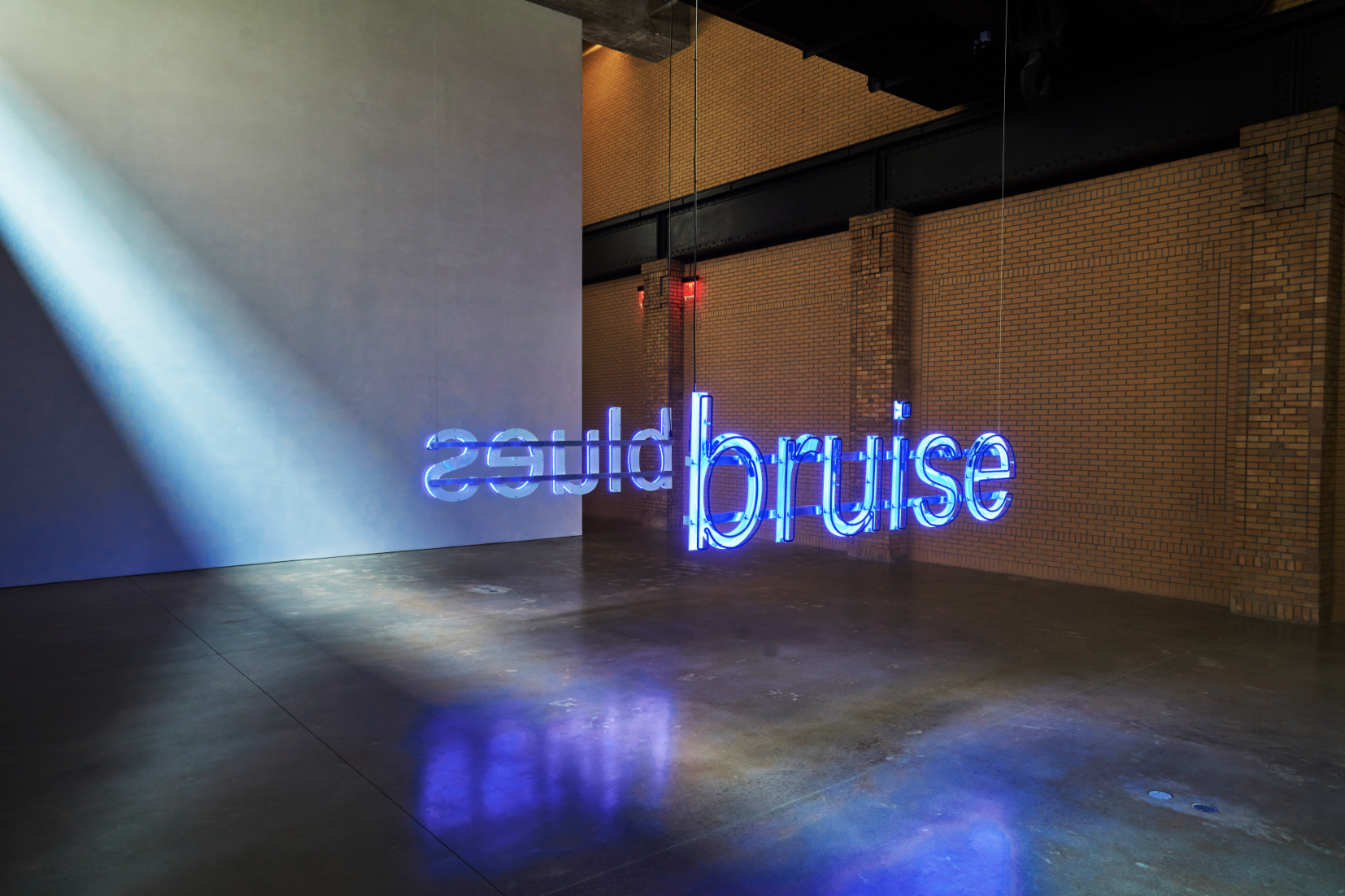 Glenn Ligon’s blue neon work Untitled (Bruise/Blues) within the gallery space