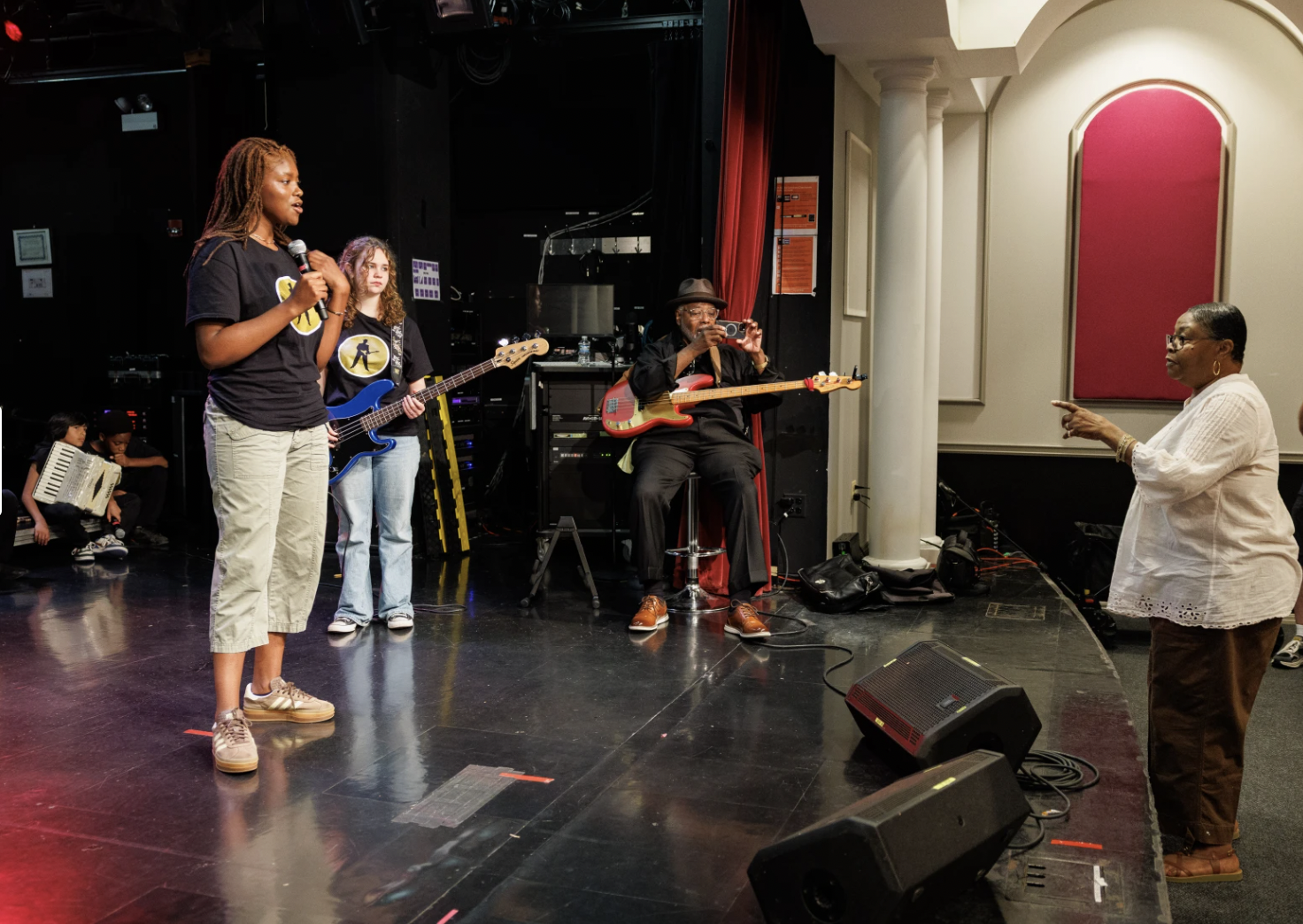 Young musicians rehearsing onstage with experienced Blues artists