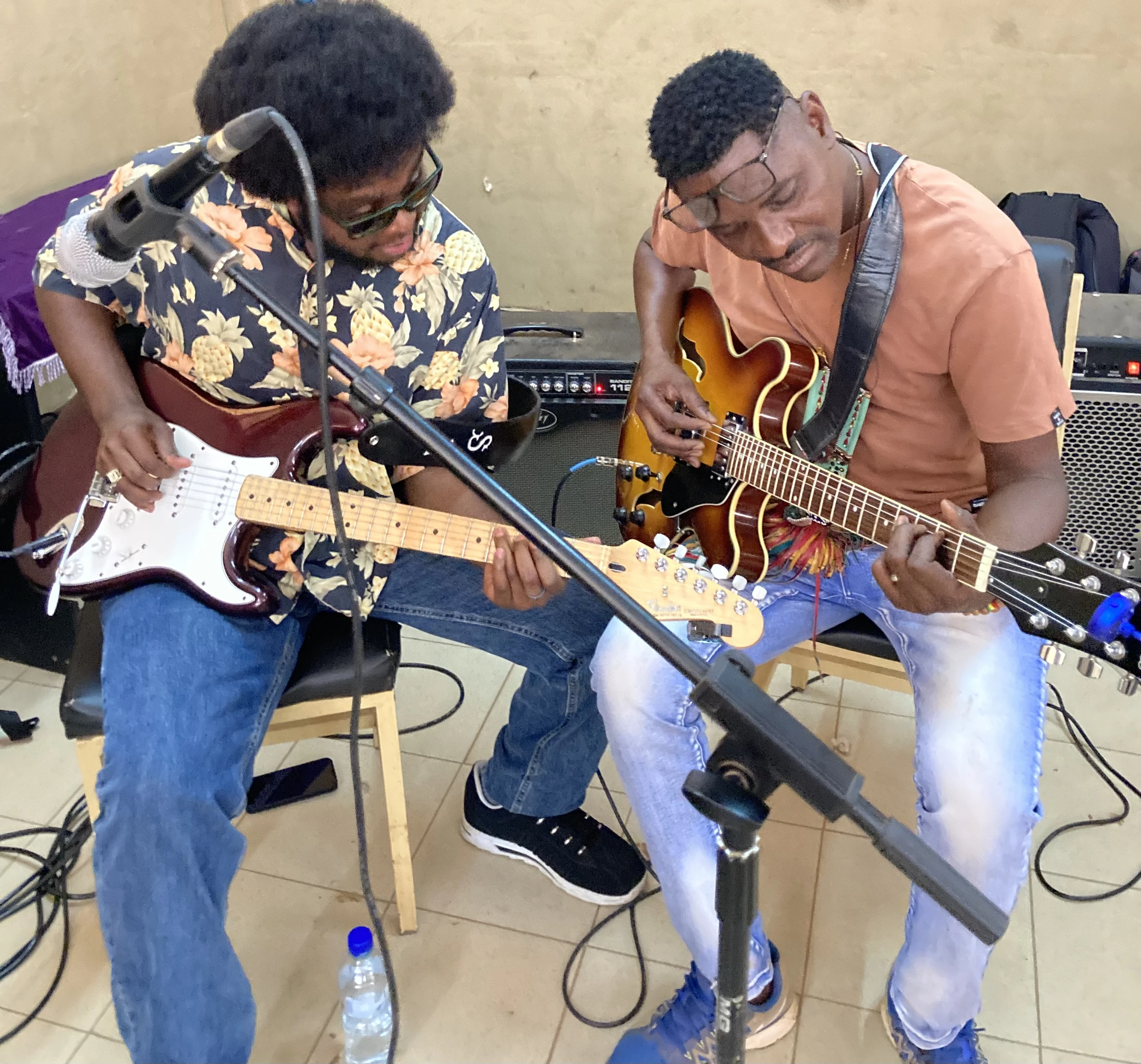 Two musicians working together during a guitar masterclass