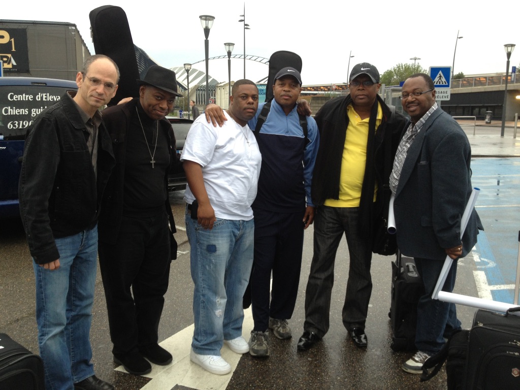 Blues musicians traveling together on tour with their instruments and luggage